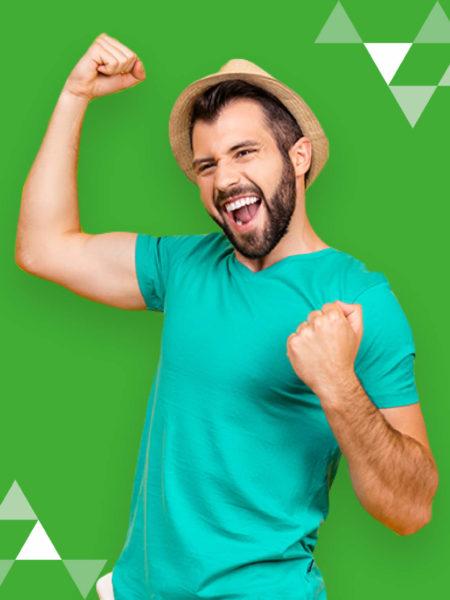 man in fedora celebrating in front of green background