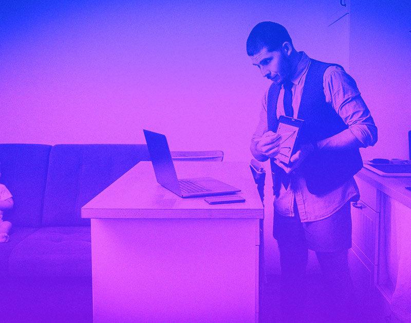 Man presenting to laptop in button down shirt and boxers