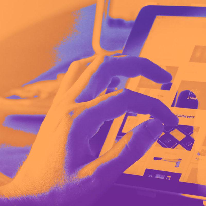 Duotone image of user interacting with a website on a tablet.