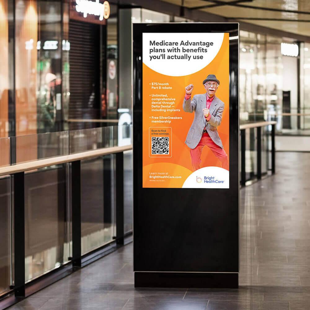 Mall advertisement kiosk displaying Bright Health Medicare Advantage plans for seniors