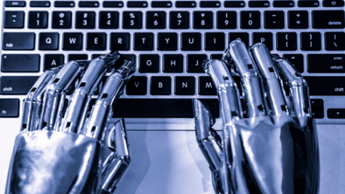 Chromed robotic hands typing on Mac laptop