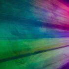 Colorful beams of light in shades of green, blue, purple, pink, and red radiate from the right side of the image, creating a vibrant, abstract pattern against a dark background.
