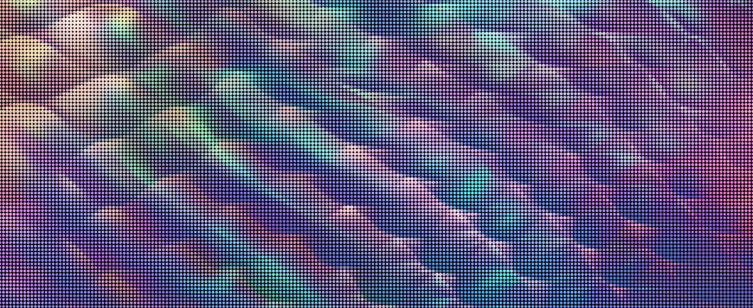 A close-up of a digital screen displaying a colorful abstract pattern with diagonal waves of pastel shades, such as green, blue, and purple, arranged in a grid of small dots.